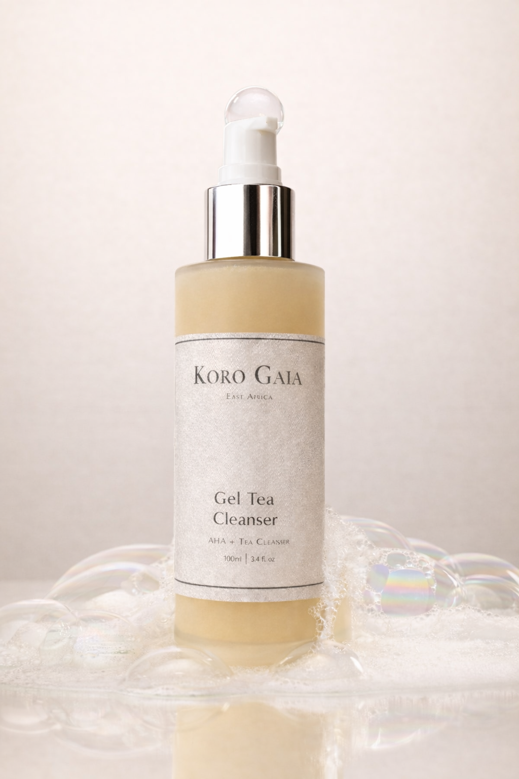 Koro Gaia Gel Tea Cleanser bottle beside botanical tea ingredients, skincare formulated for melanin-rich skin
