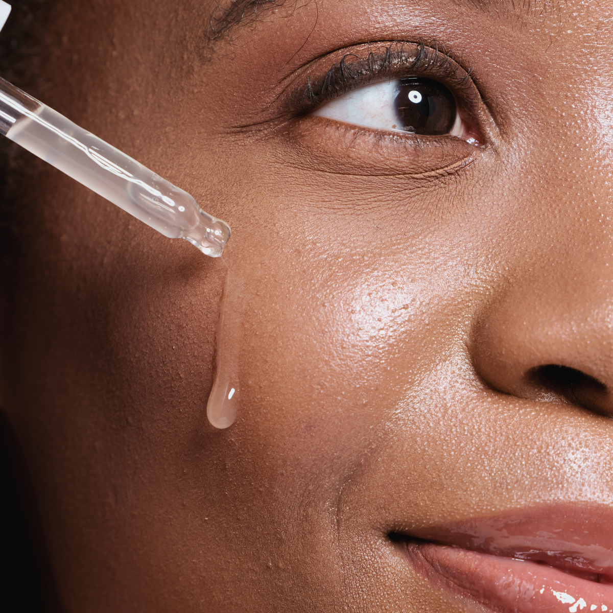 AHA exfoliating acid serum being applied to skin, weekly treatment step