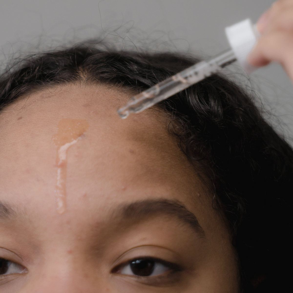 PHA polyhydroxy acid serum applied to skin, gentle exfoliation for reactive skin